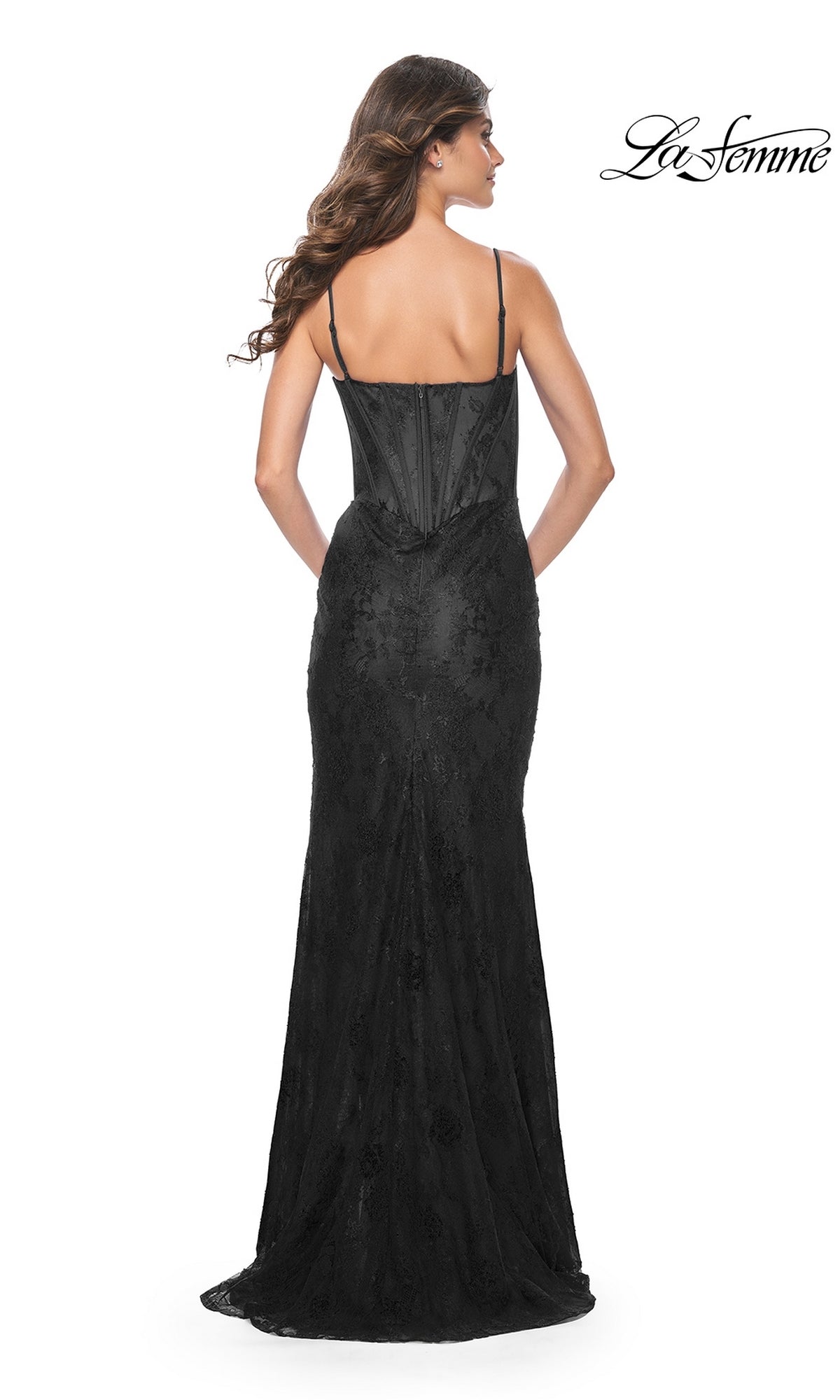Woman wearing the La Femme Corset-Bodice Long Lace Prom Dress 32231 featuring a fitted black floral lace design and thin straps, shown from the back against a white background with